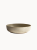 A shallow, round ceramic bowl with a speckled beige and light grey texture, on a plain white background.