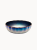 A round ceramic bowl featuring a fluted design with an iridescent, shimmering glaze that gradients from deep metallic blue to white. The artistic dish is highlighted by a delicate gold scalloped rim