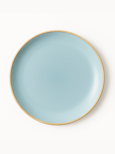 A top-down view of a round ceramic plate featuring a smooth matte finish in light blue with a clean gold rim. The minimalist dish is centered against a solid white background.