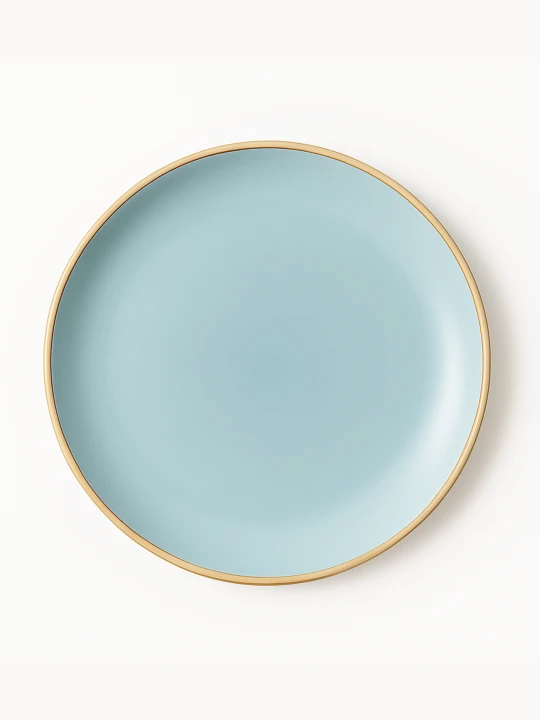 A top-down view of a round ceramic plate featuring a smooth matte finish in light blue with a clean gold rim. The minimalist dish is centered against a solid white background.