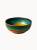 A round ceramic bowl with a glossy reactive glaze featuring a gradient of deep teal, turquoise, and a warm honey-amber center.