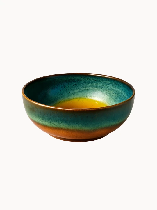 A round ceramic bowl with a glossy reactive glaze featuring a gradient of deep teal, turquoise, and a warm honey-amber center.