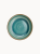 A top-down view of a round ceramic plate featuring a glossy teal and turquoise glaze with concentric swirl patterns and a brown rim.