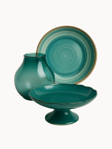 A top-down view of a round ceramic bowl with a glossy teal and turquoise swirl pattern and a brown rim. The minimalist dish is isolated against a plain white background.