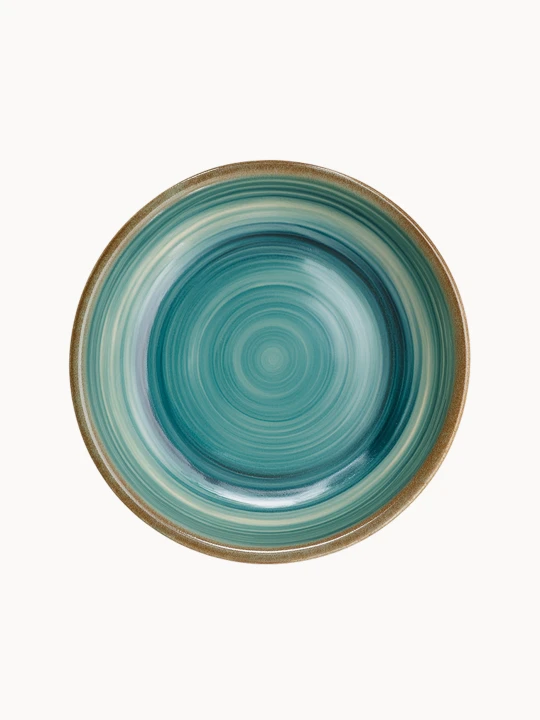 A top-down view of a round ceramic plate featuring a glossy teal and turquoise glaze with concentric swirl patterns and a brown rim.