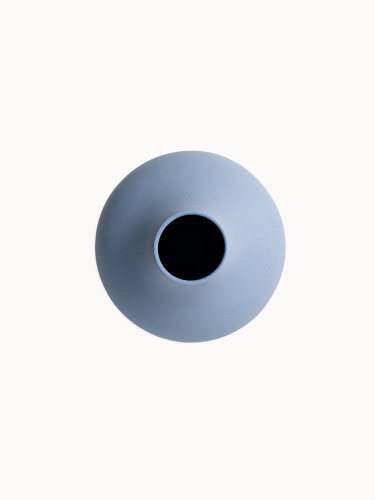 A  top-down view on a ceramic vase with a matte, textured light blue finish isolated on a plain white background.