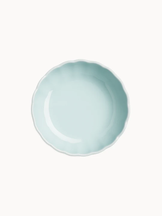 A top-down view on a pastel blue ceramic cake stand, on a light background.