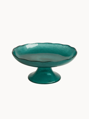 A vibrant teal cake stand with a distinct ruffled edge and a short, conical teal base. ona light cream white background.