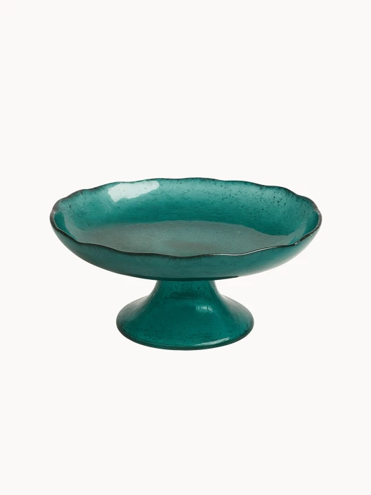 A vibrant teal cake stand with a distinct ruffled edge and a short, conical teal base. ona light cream white background.