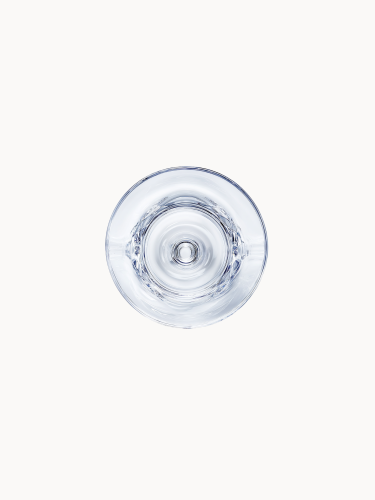 A top-down photograph looking directly into the clear crystal base, on a light background.
