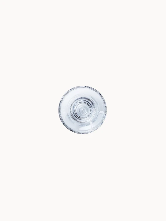 A round, glass base of a champagne, bottom view on a white background.