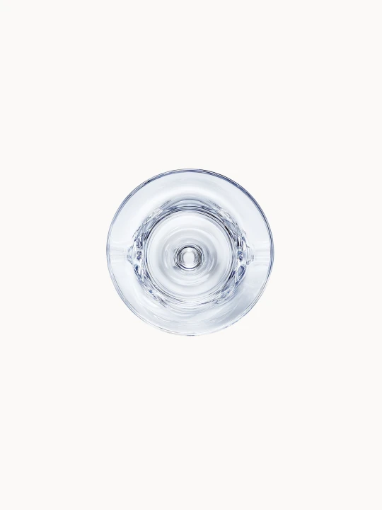 The bottom of a martini glass, viewed from below, reveals the precise geometry of the stable crystal base.
