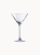 A classic, clear martini glass with a conical bowl resting on a slender stem.